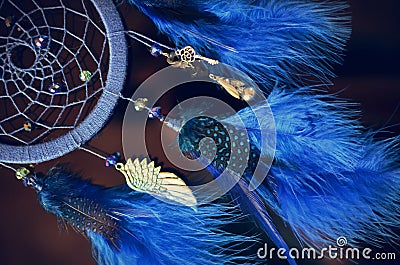 Blue dream catcher hanging on dark background Stock Photo