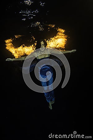 Blue dressed girl with underwater firewings Stock Photo