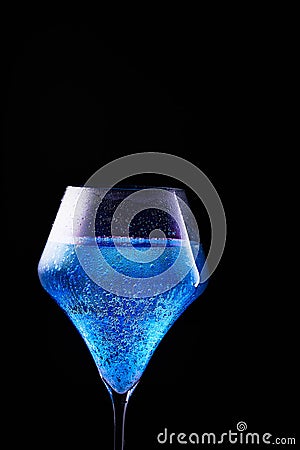 Blue drink is poured into a glass. Stock Photo