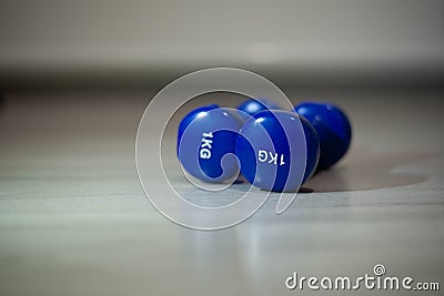 Blue dumbbells on the floor Stock Photo