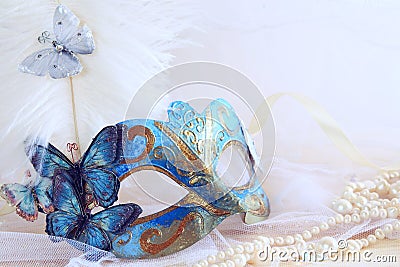 blue elegant venetian mask next to pearls Stock Photo