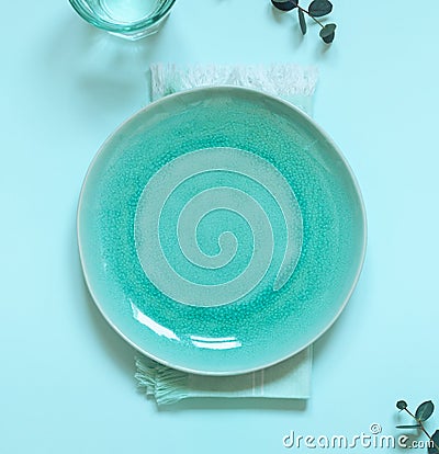 Blue empty plate flat lay with napkin on the table. Table settings composition Stock Photo