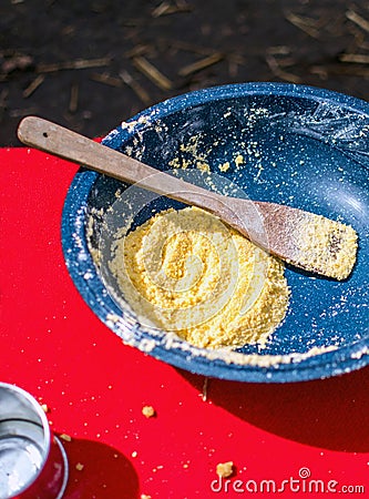 Blue enamel bowl with corn meal mix for johnny cakes Stock Photo