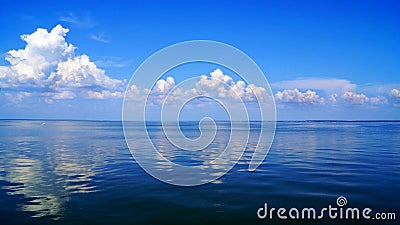 Blue expanse of the sea and blue sky with clouds Stock Photo