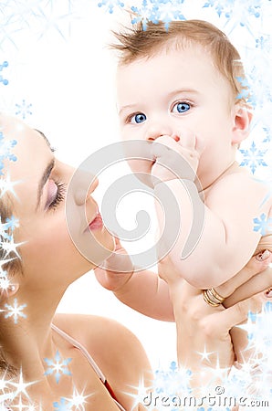 Blue-eyed baby in mother hands Stock Photo