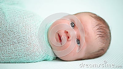 Blue-eyed newborn baby lying and looking around in wonder. HD Blue-eyed newborn baby lying and looking around in wonder. HD