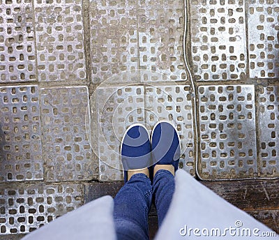 Blue fabric slip-ons. Photo of legs in jeans and shoes from top to bottom Stock Photo