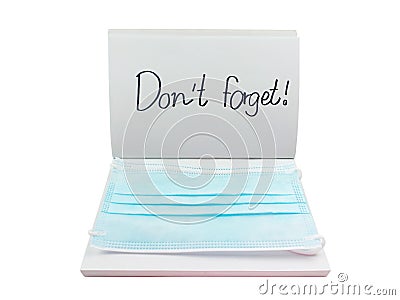 Blue face mask on white notebook or sketch with text Stock Photo