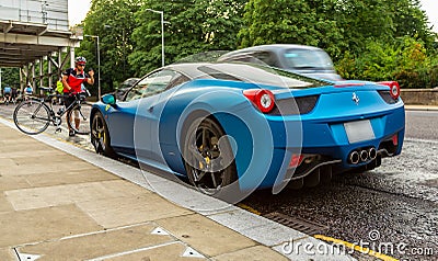 Blue Ferrari 458 parked in street in London Editorial Stock Photo