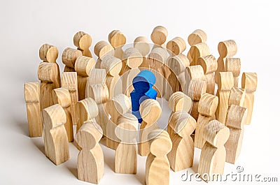 The blue figure of the leader is surrounded by a crowd of people. Leadership and team management, an example for imitation Stock Photo