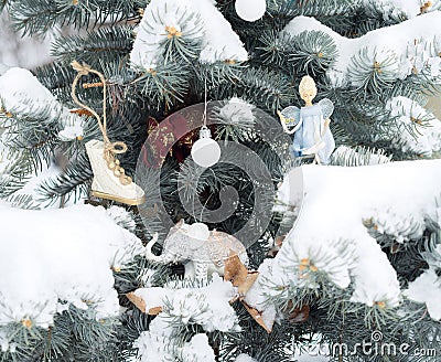 Blue fir-tree is decorated by Christmas toys. Elephants, angel, Stock Photo