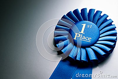 Blue first place winner rosette Stock Photo