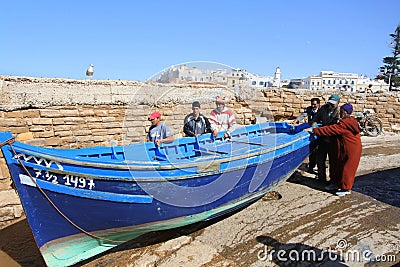 Blue fishing boat being launched Editorial Stock Photo