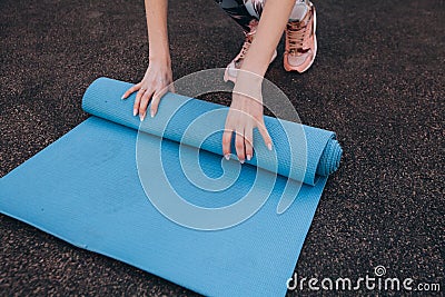 Blue fitness Mat after training at the stadium Stock Photo