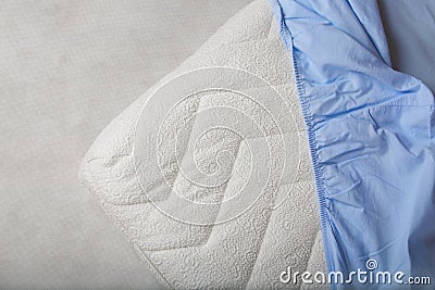 Blue fitted sheet on a mattress. Stock Photo