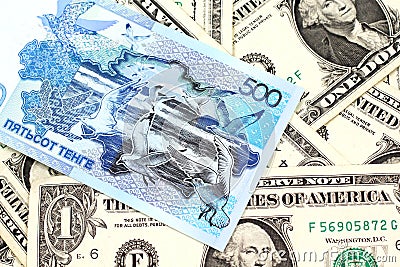 A blue tenge note from Kazakhstan with American one dollar bills Stock Photo