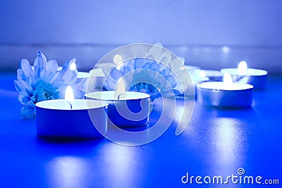 Blue flower and tea candles Stock Photo