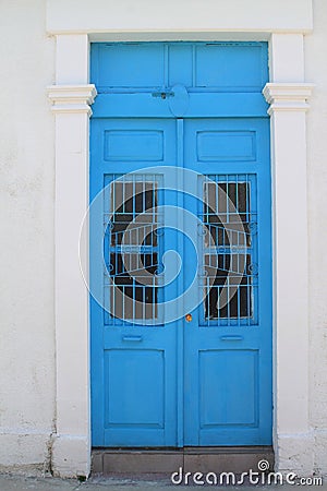 Blue front door in white stone wall Stock Photo