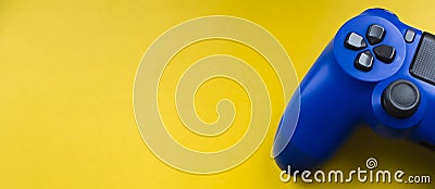 Blue gamepad on a bright yellow background. Stock Photo