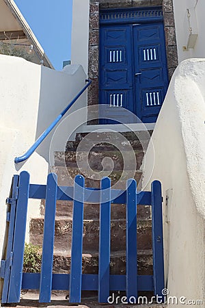 Blue Gate and Steps Leading to Blue Door Stock Photo