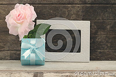 Blue gift box with blank frame and oink rose Stock Photo