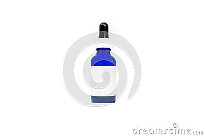 Blue glass eyedropper bottle isolated on white, with blank white label for adding your own text or logo. Bottle is transparent and Stock Photo