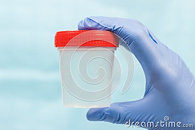 Blue gloved hand holding a jar Stock Photo