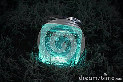 Blue glowing jar on the moss Stock Photo