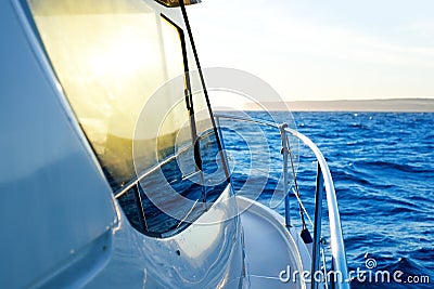 Blue golden sunrise sailing on boat side Stock Photo