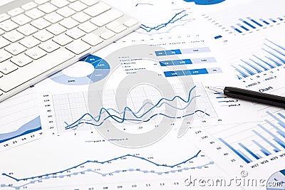 Blue graph and chart reports on office table Stock Photo