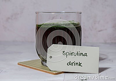 Blue-green algae Chlorella and spirulina powder drink with paper note text SPIRULINA DRINK. Super powder. Natural Stock Photo
