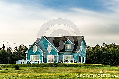 Blue green cottage style home with great patio, lawn and porch Stock Photo