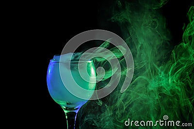 Blue and green smoke in a glass. Halloween. Stock Photo