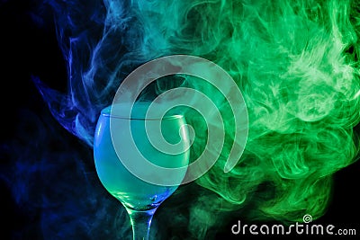 Blue and green smoke in a glass. Halloween. Stock Photo