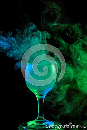 Blue and green smoke in a glass. Halloween. Stock Photo