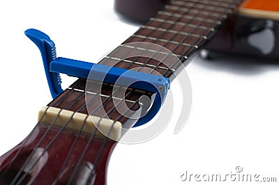 Blue guitar capo and guitar isolated on white background Stock Photo
