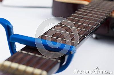 Blue guitar capo and guitar isolated on white background Stock Photo