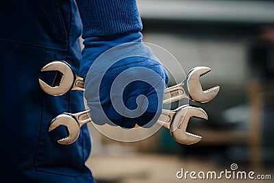 Blue hand grips wrenches, symbolizing manual labor, repair work, or craftsmanship Stock Photo