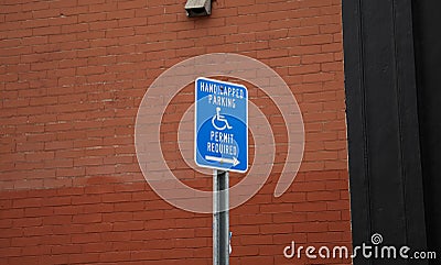 Blue handicap sign on the street - a symbol for mobility aid for people with disabilities Stock Photo