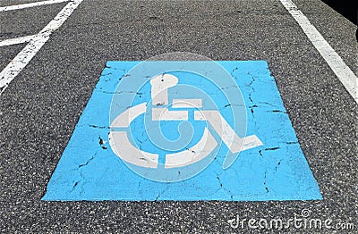 Blue Handicapped Symbol on Parking Pavement Stock Photo