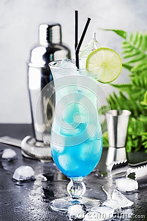 Blue Hawaii or Blue Lagoon - summer alcoholic cocktail with vodka, liqueur, tonic, pineapple juice and ice, in high Hurricane Stock Photo