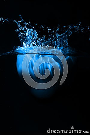 Blue heart splashing on water Stock Photo