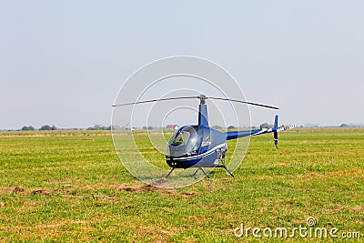 Blue helicopter on field Stock Photo