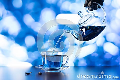 Blue hot tea is poured into a glass cup Stock Photo