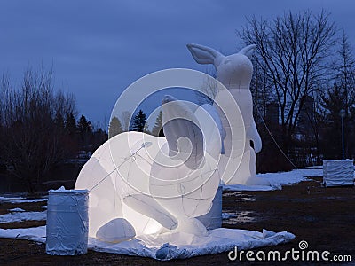 Blue hour view of two glowing giant inflatable rabbits Editorial Stock Photo