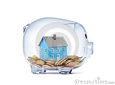 Blue house on money inside transparent piggy bank Stock Photo