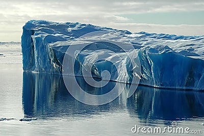 Blue iceberg with reflection Stock Photo