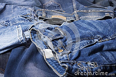 Blue jeans background overlapping Modern fashion jeans - top view Stock Photo