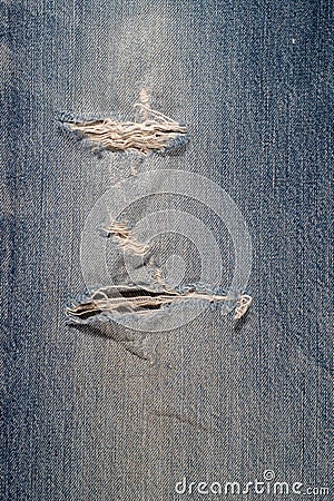Blue jeans canvas ripped damaged for background Stock Photo