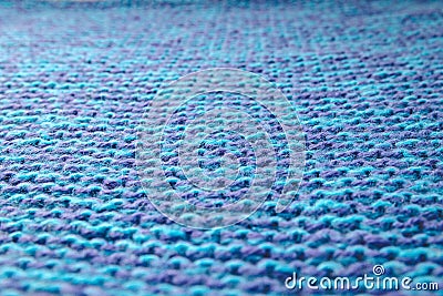 Blue knitted background. Knitted texture. A sample of knitting. Knitting Pattern. Stock Photo
